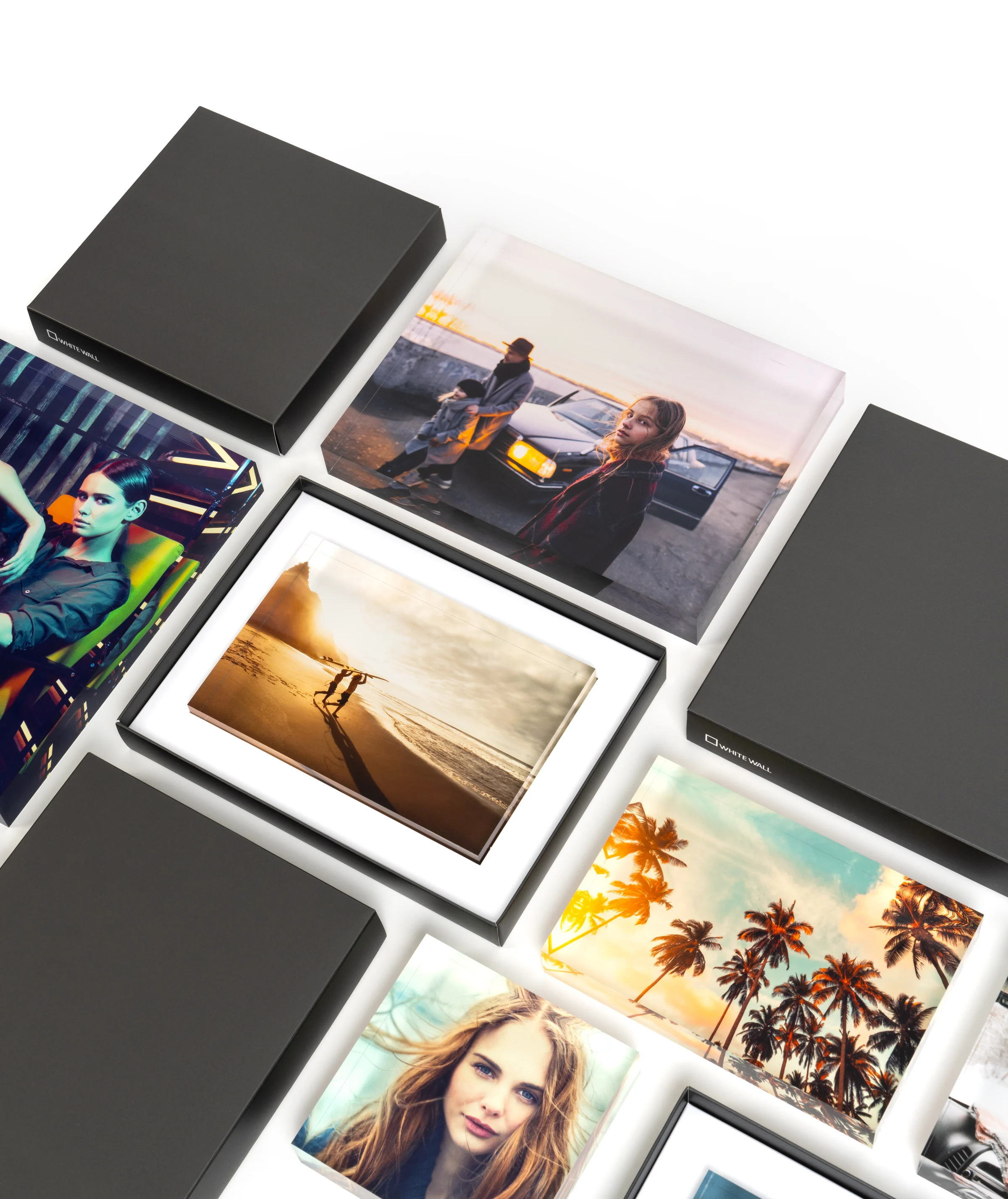 multiple acrylic photo blocks with and without gift box and closed gift boxes lying in a pattern to show the different formats.