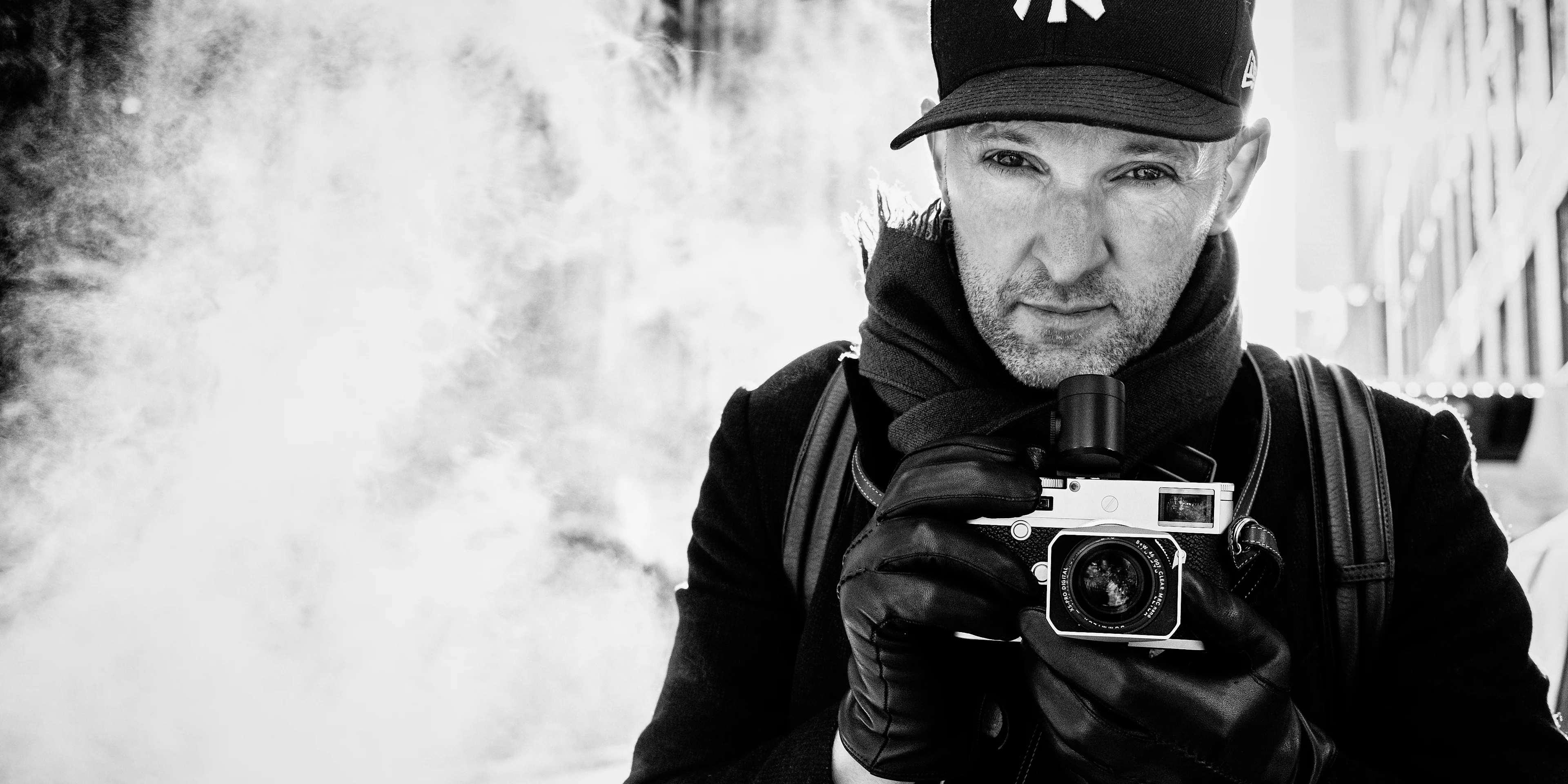 Photographer Phil Penman with a camera in his hands.