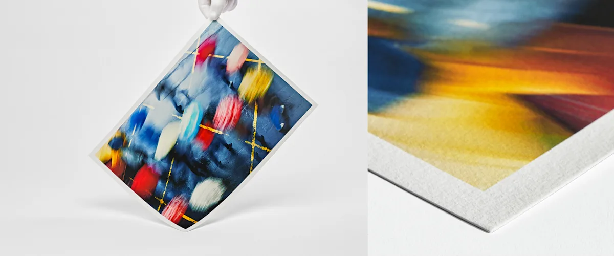 Fine Art Paper Hahnemühle German Etching Hand with white gloves holding fine art print with landscape motif on glossy baryta paper.