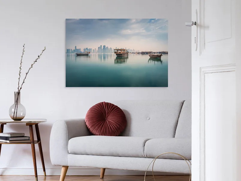 Photo Print On Aluminum Backing Three boats are reflected on the calm surface of the sea, visible on a photo print on an aluminum base.