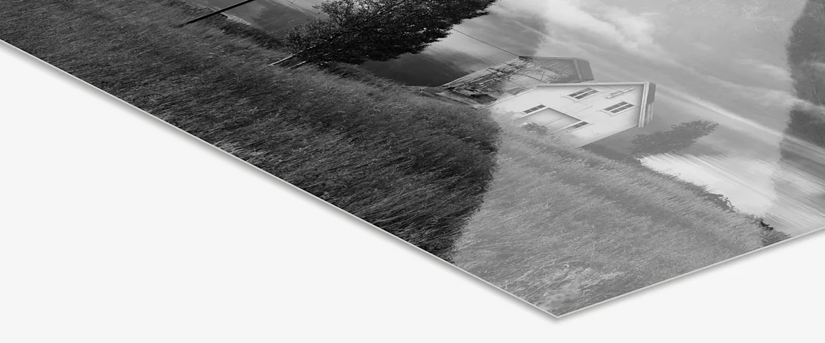 black & white Photo Print Under Matte Acrylic Glass Close up of the black & white photo paper under matte acrylic glass with house in landscape motif