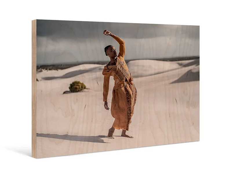 PDP | Direct Print on Wood | Product Selector Section | Media #1 A person stands in front of sand dunes in a desert on a Direct Print on Wood.