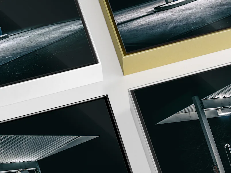 PDP | Aluminium ArtBox | Product Selector Section | Media #2 Close up of four ArtBox Aluminum frames in different colors (black, silver, white and gold) on a grey desk.