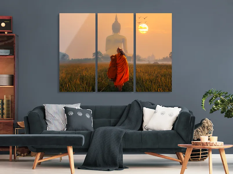 PDP | Multi Panel Wall Art | Product Selector Section | Media #2 A monk is standing in front of a huge Buddha statue. The whole picture is divided into three parts.
