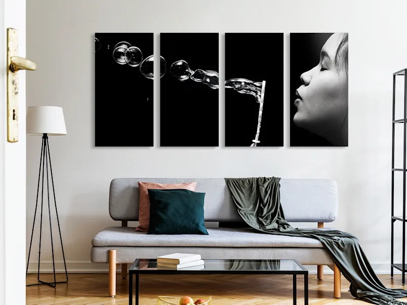 PDP | Multi Panel Wall Art | Product Selector Section | Media #4 A woman is blowing soap bubbles. The whole picture is divided into four parts hanging horizontally on the wall.